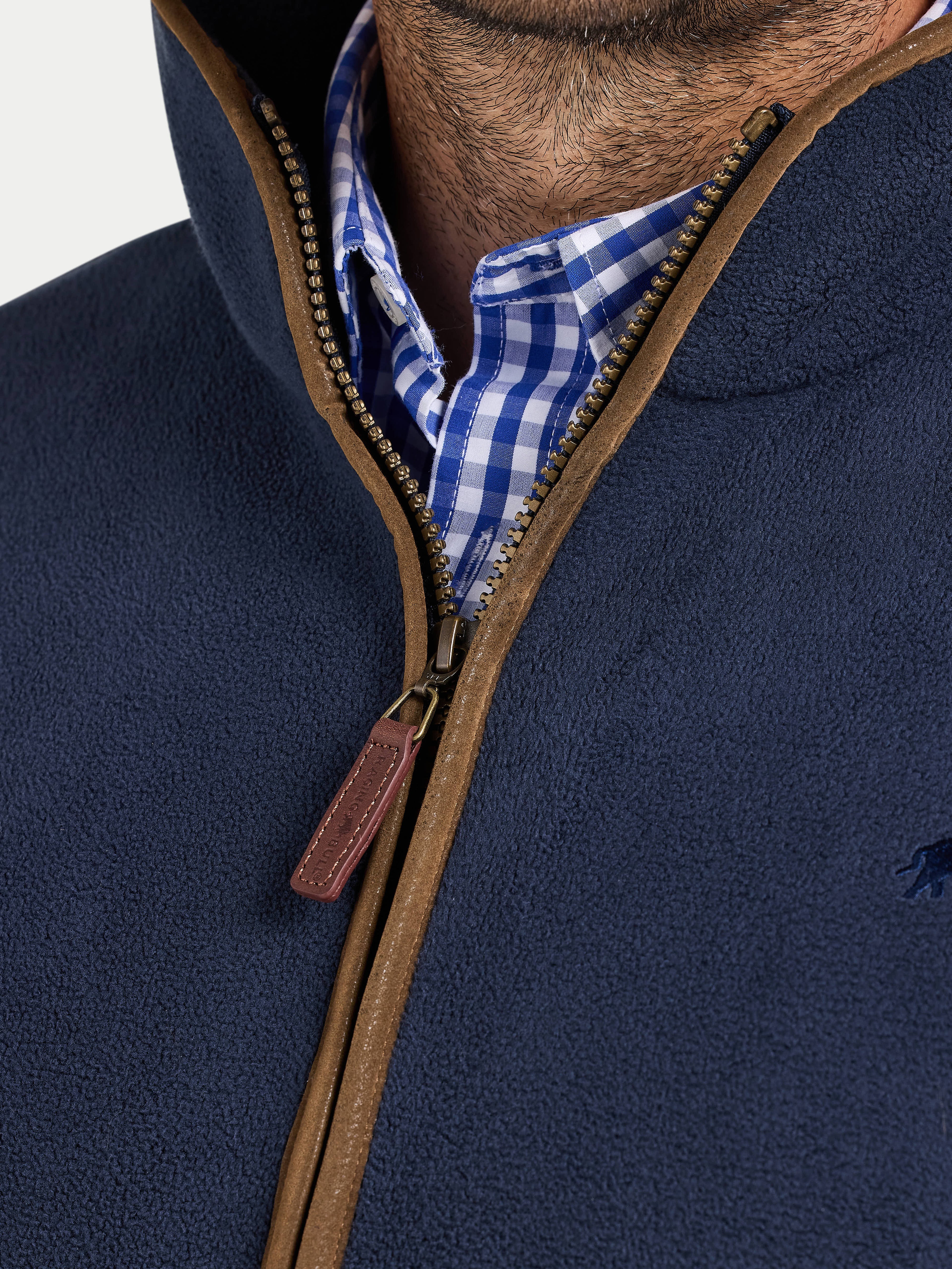 Navy blue jacket with brown zipper and checkered shirt collar
