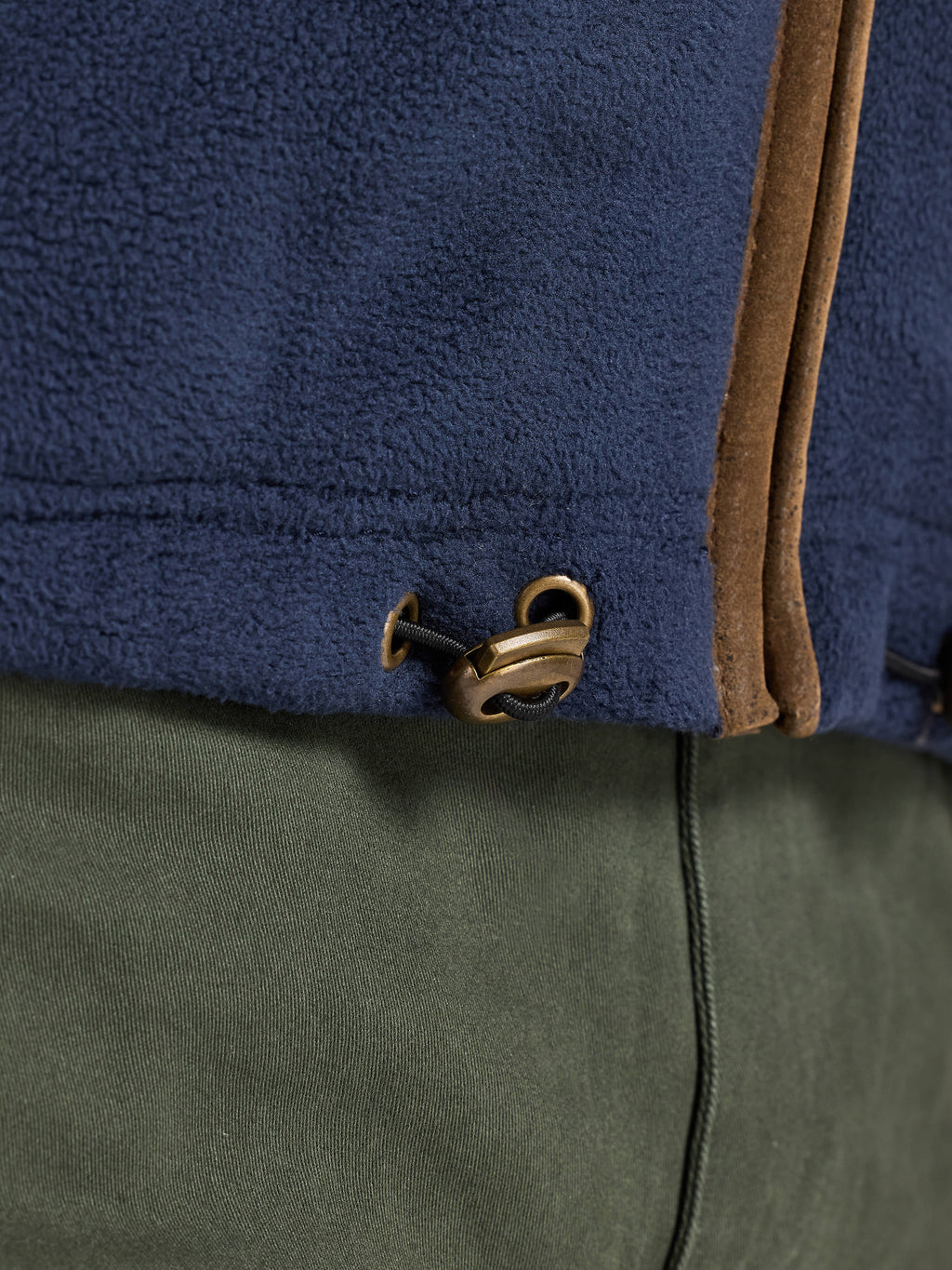 Close-up of a blue and green jacket with a zipper detail