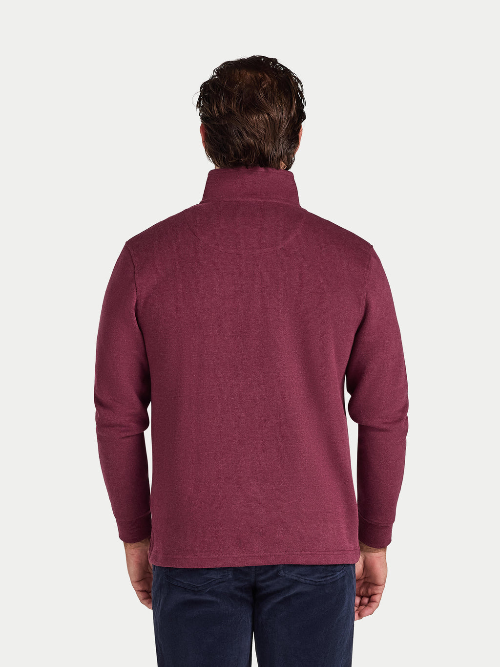 Man wearing a maroon fleece pullover on a white background