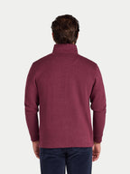Man wearing a maroon fleece pullover on a white background