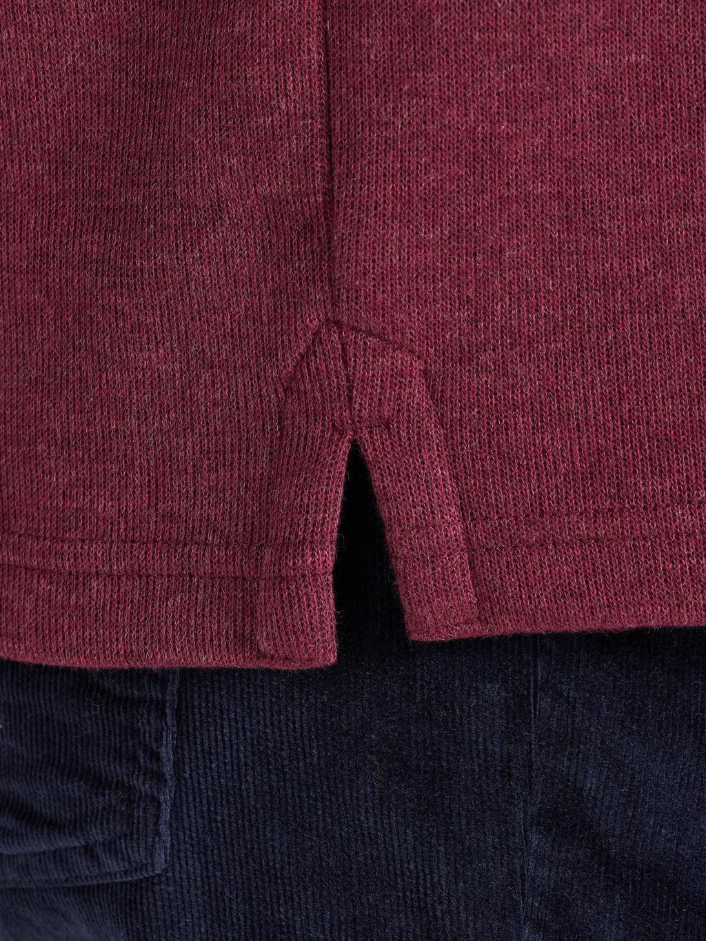 Close-up of a maroon textured fabric with a dark background