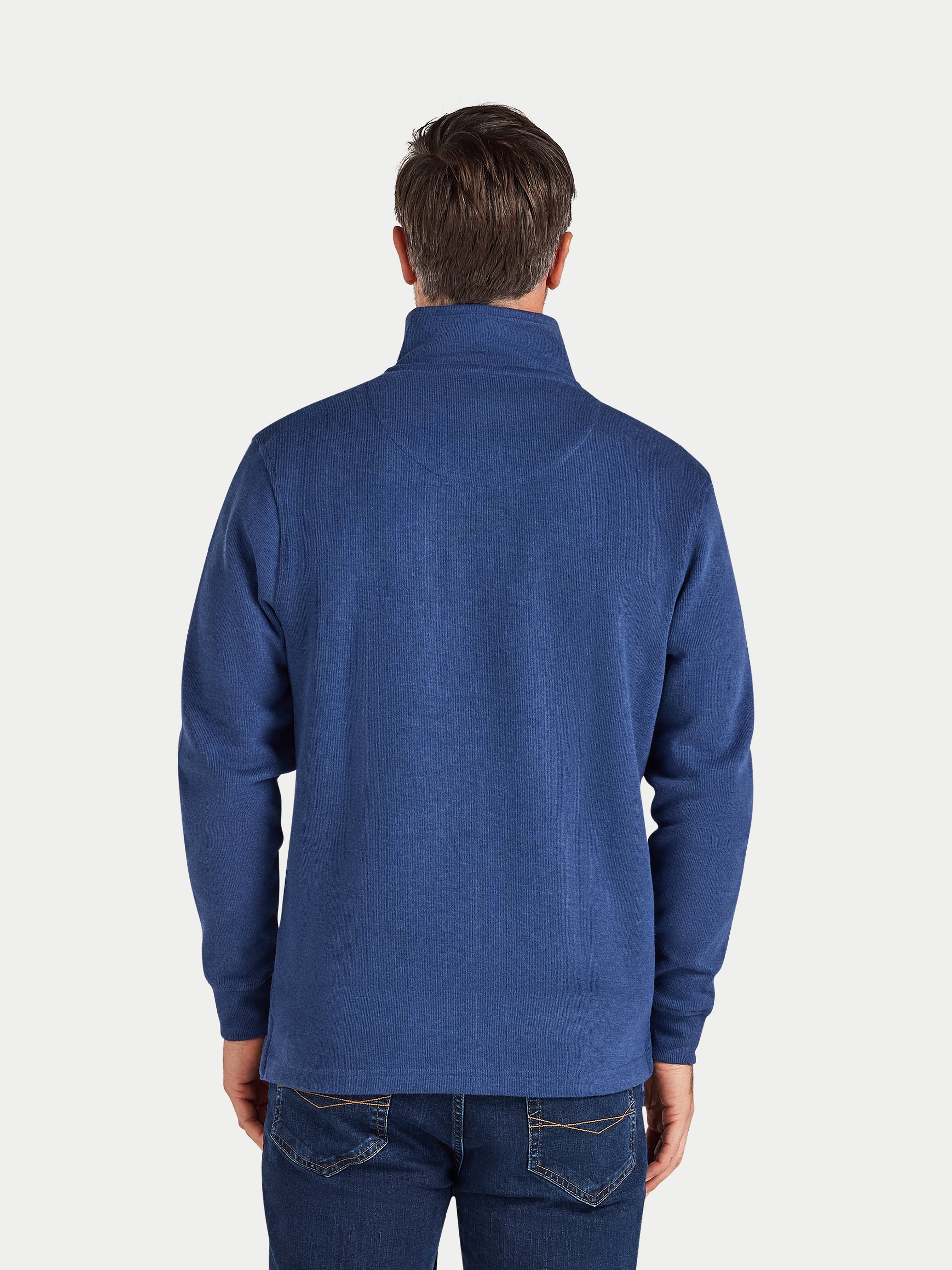 Man wearing a blue sweater on a white background