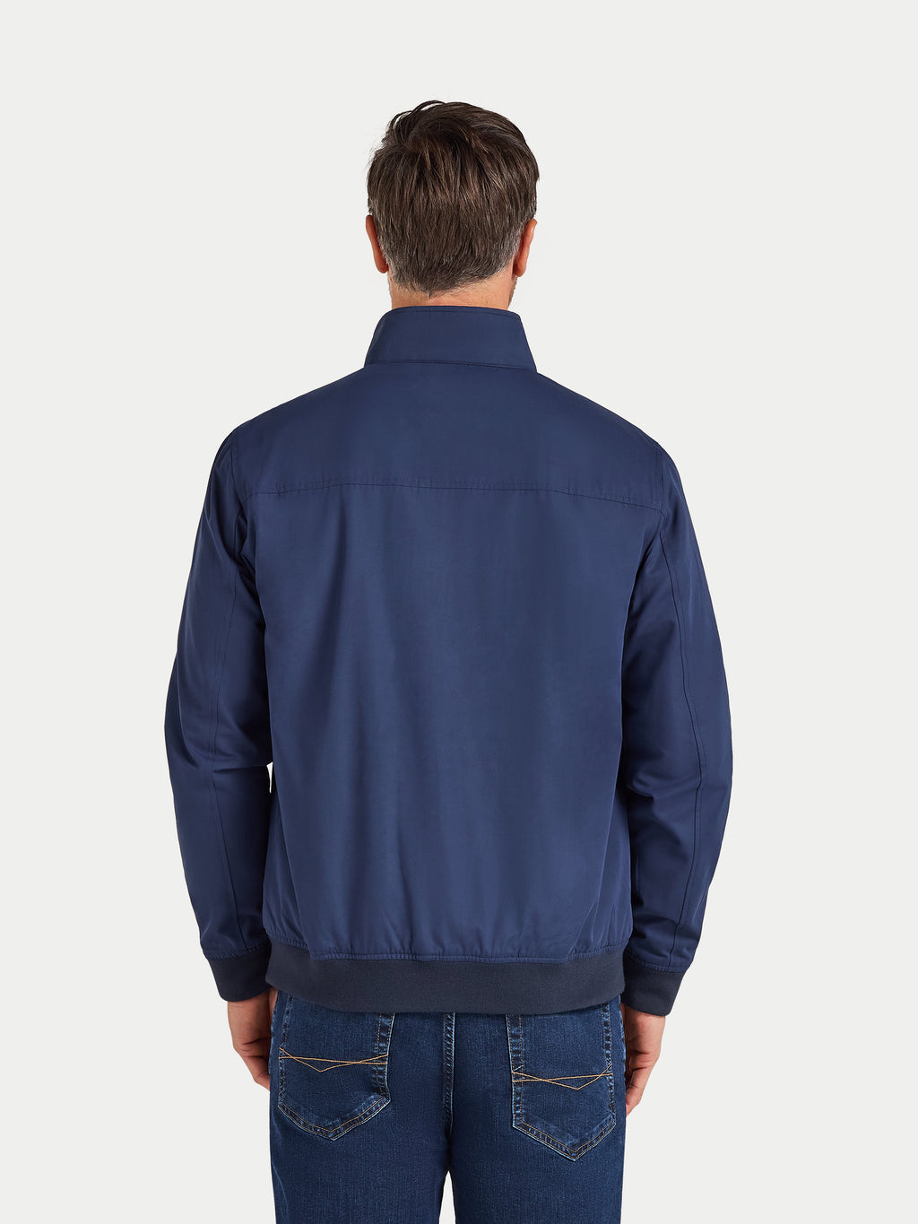 Man wearing a navy blue jacket on a white background