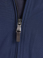 Close-up of a navy blue jacket zipper.