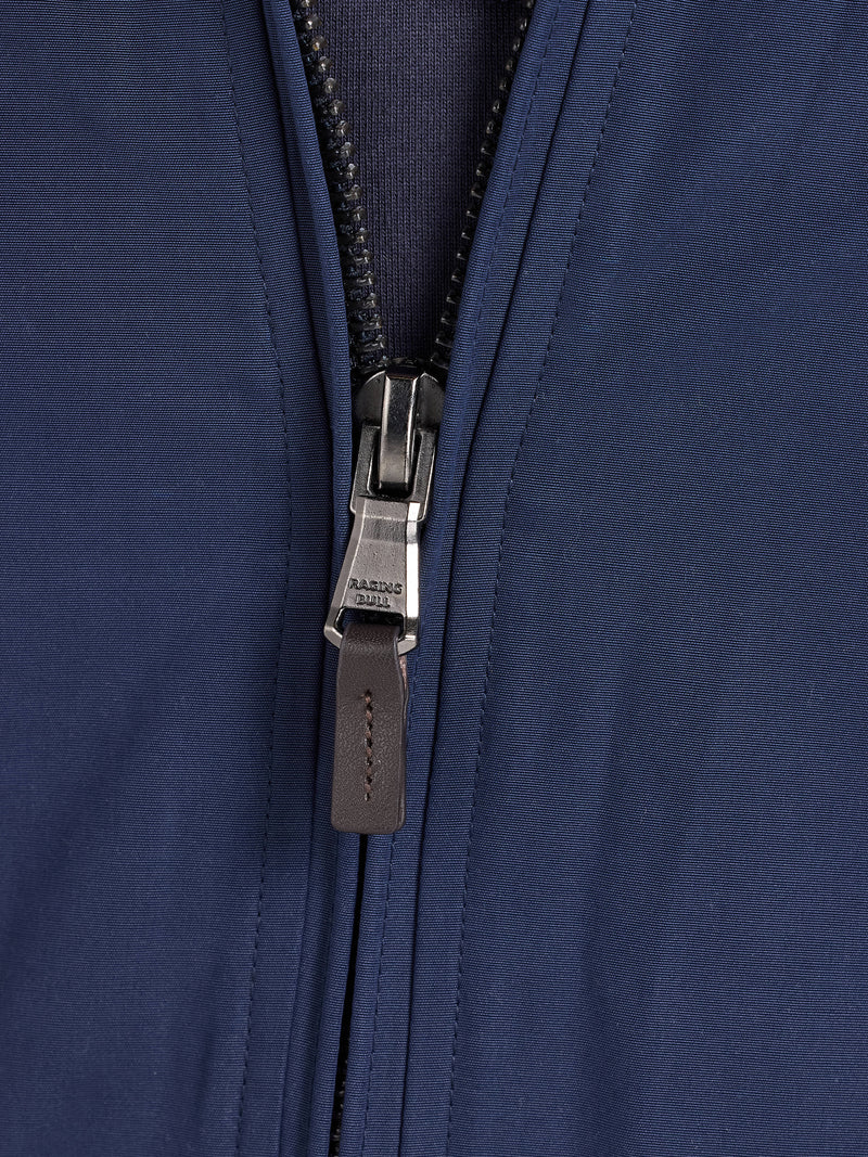 Close-up of a navy blue jacket zipper.