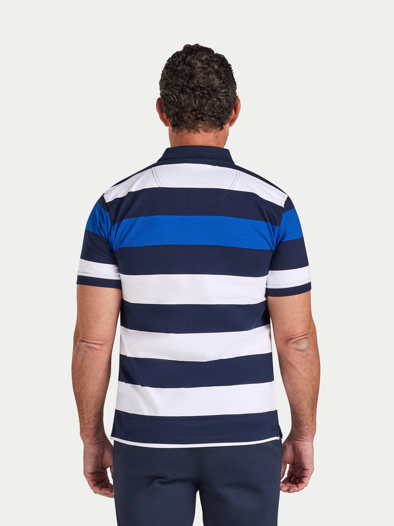 Man wearing a blue and white striped polo shirt on a light gray background