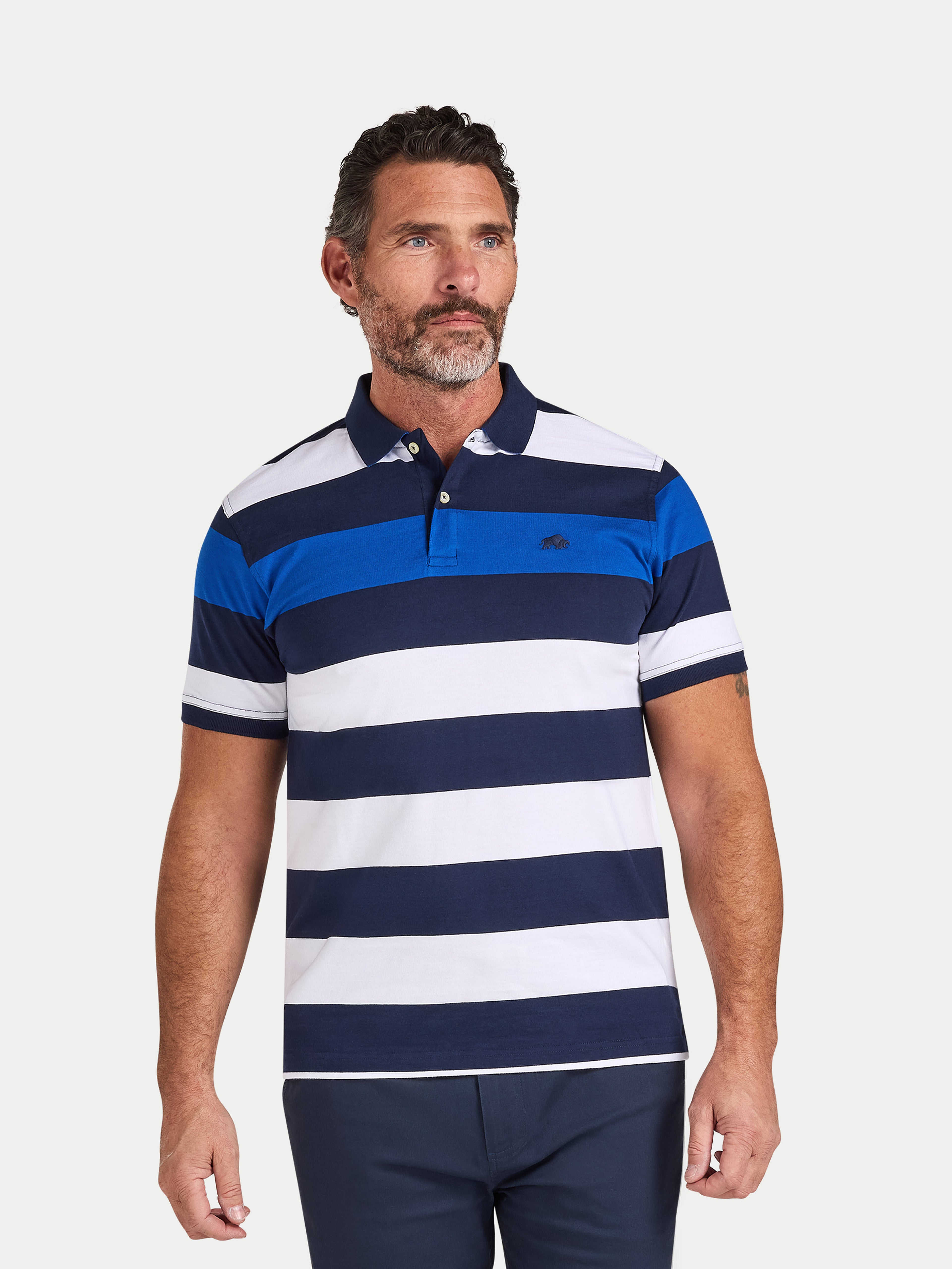 Man wearing a blue and white striped polo shirt on a light gray background