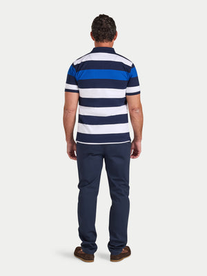 Man wearing a blue and white striped polo shirt and navy pants on a white background
