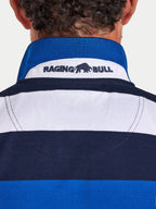 Close-up of a person wearing a blue and white striped shirt with 'Raging Bull' logo.