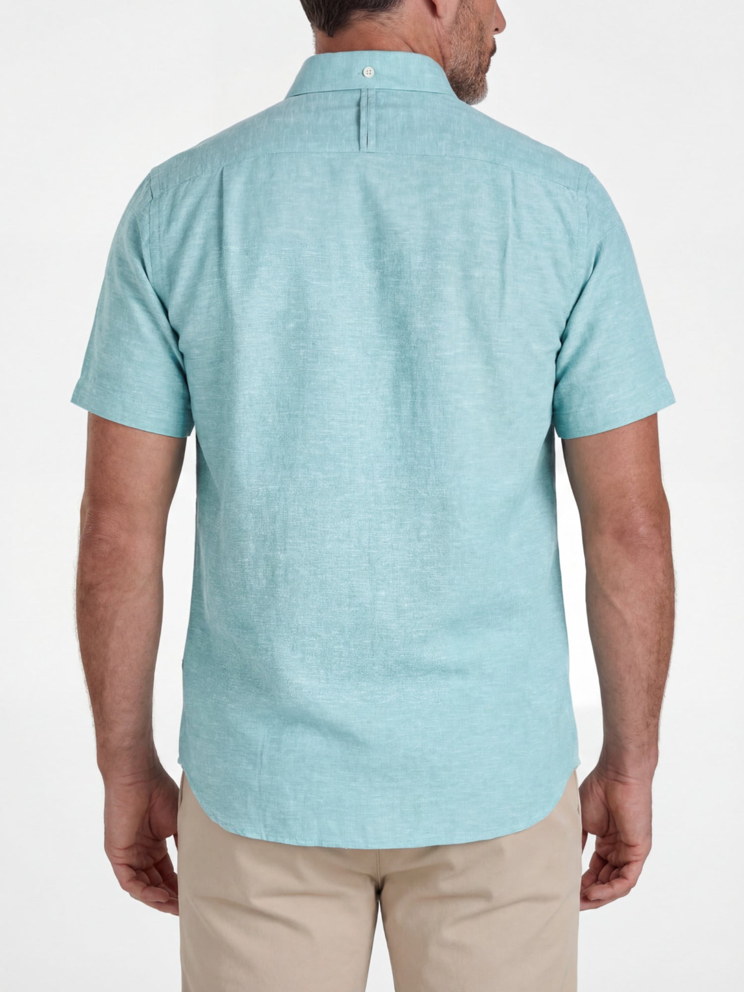 Man wearing a light apple green short-sleeve shirt on a white background