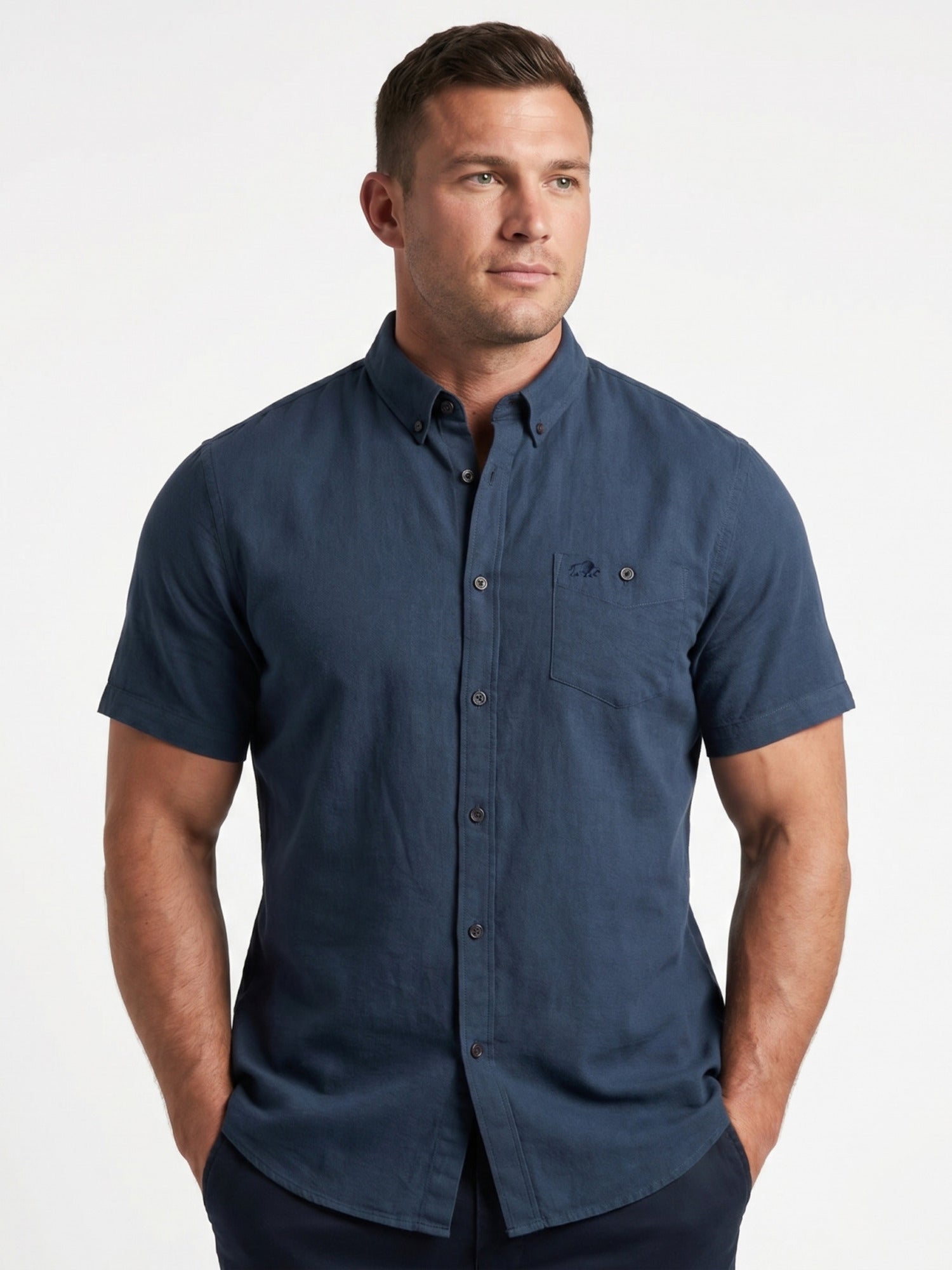 Man wearing a blue short-sleeve shirt on a white background