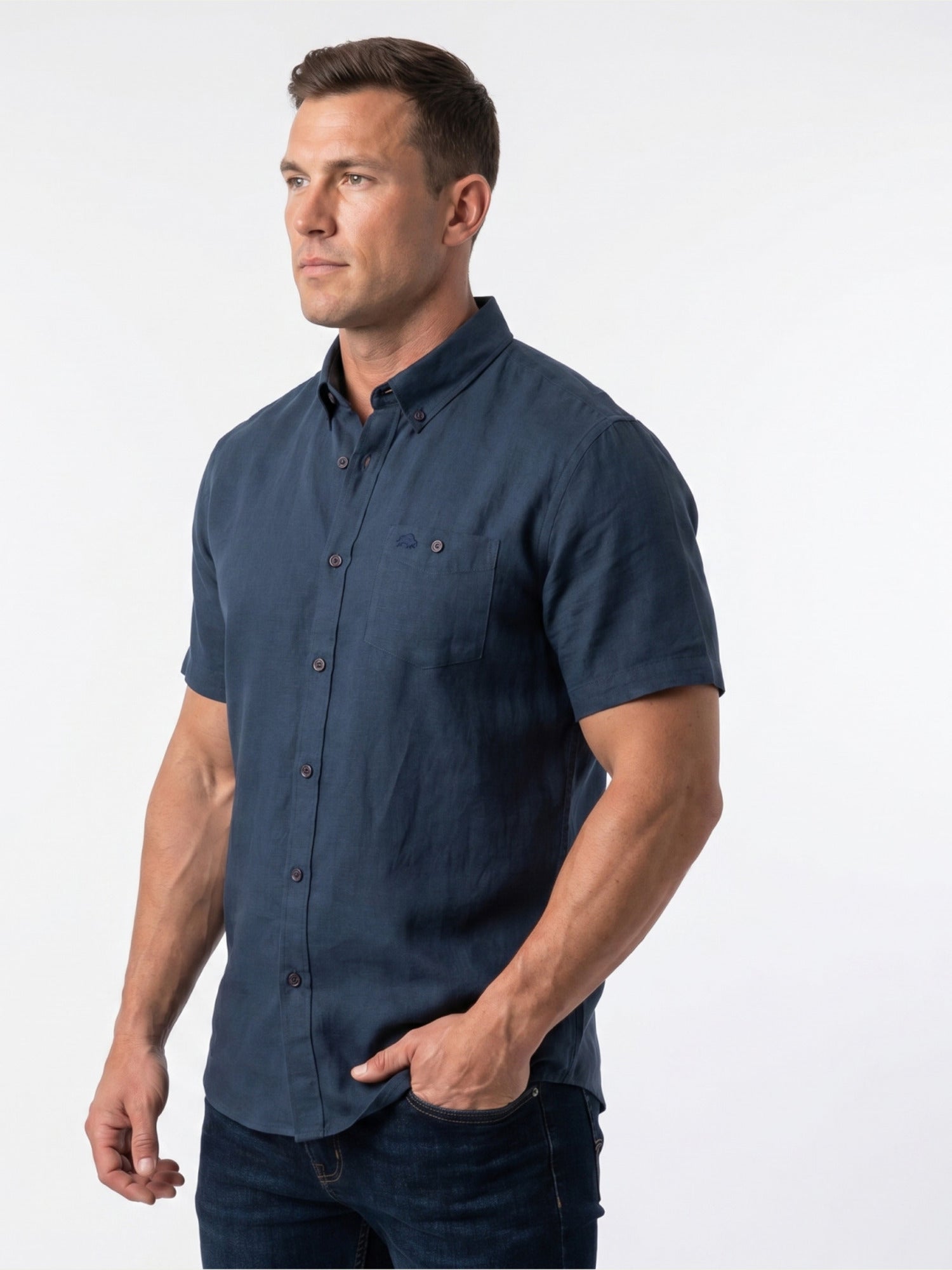 Man wearing a navy blue short-sleeve shirt on a white background