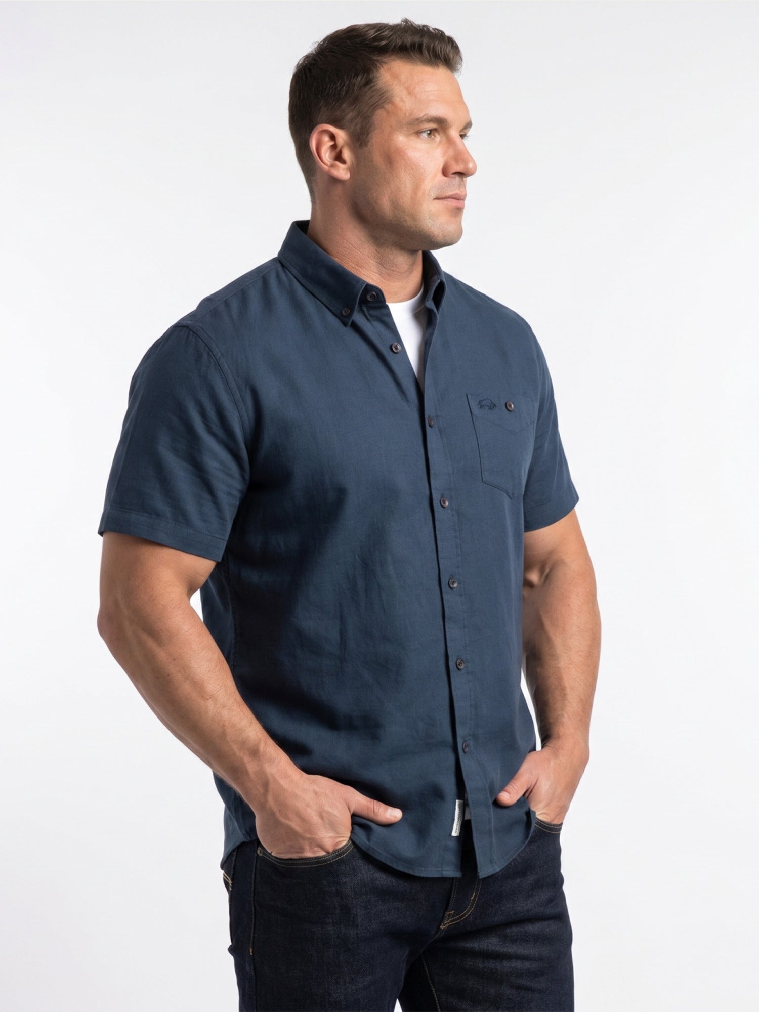 Man wearing a navy blue short-sleeve shirt on a white background