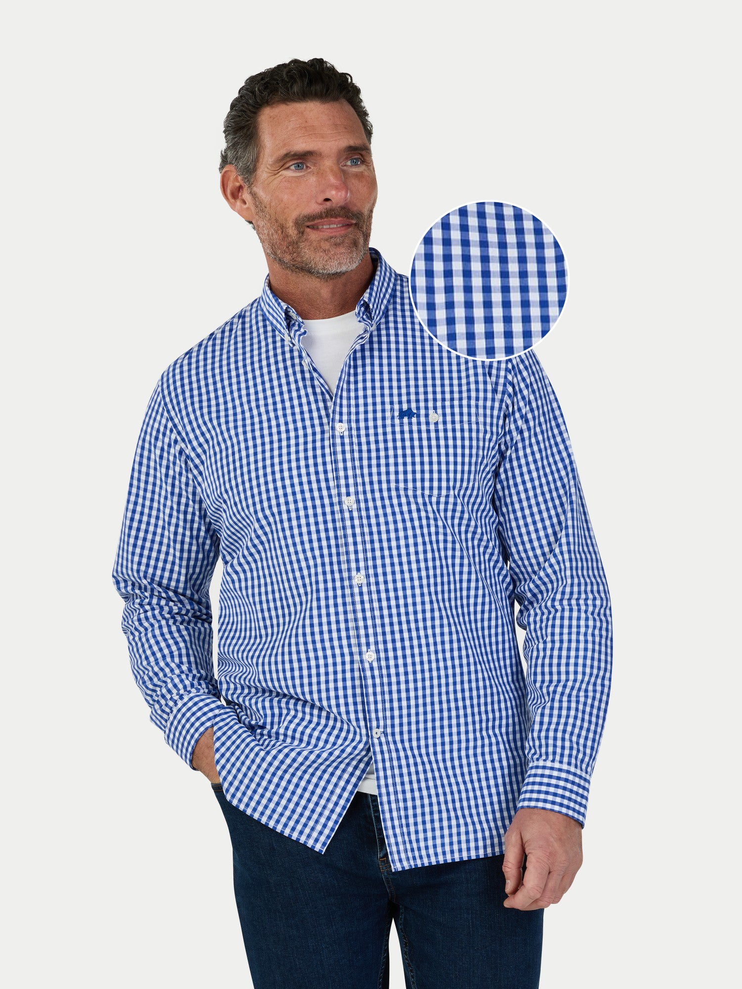 Man wearing a blue checkered shirt with a close-up of the fabric pattern on a white background.
