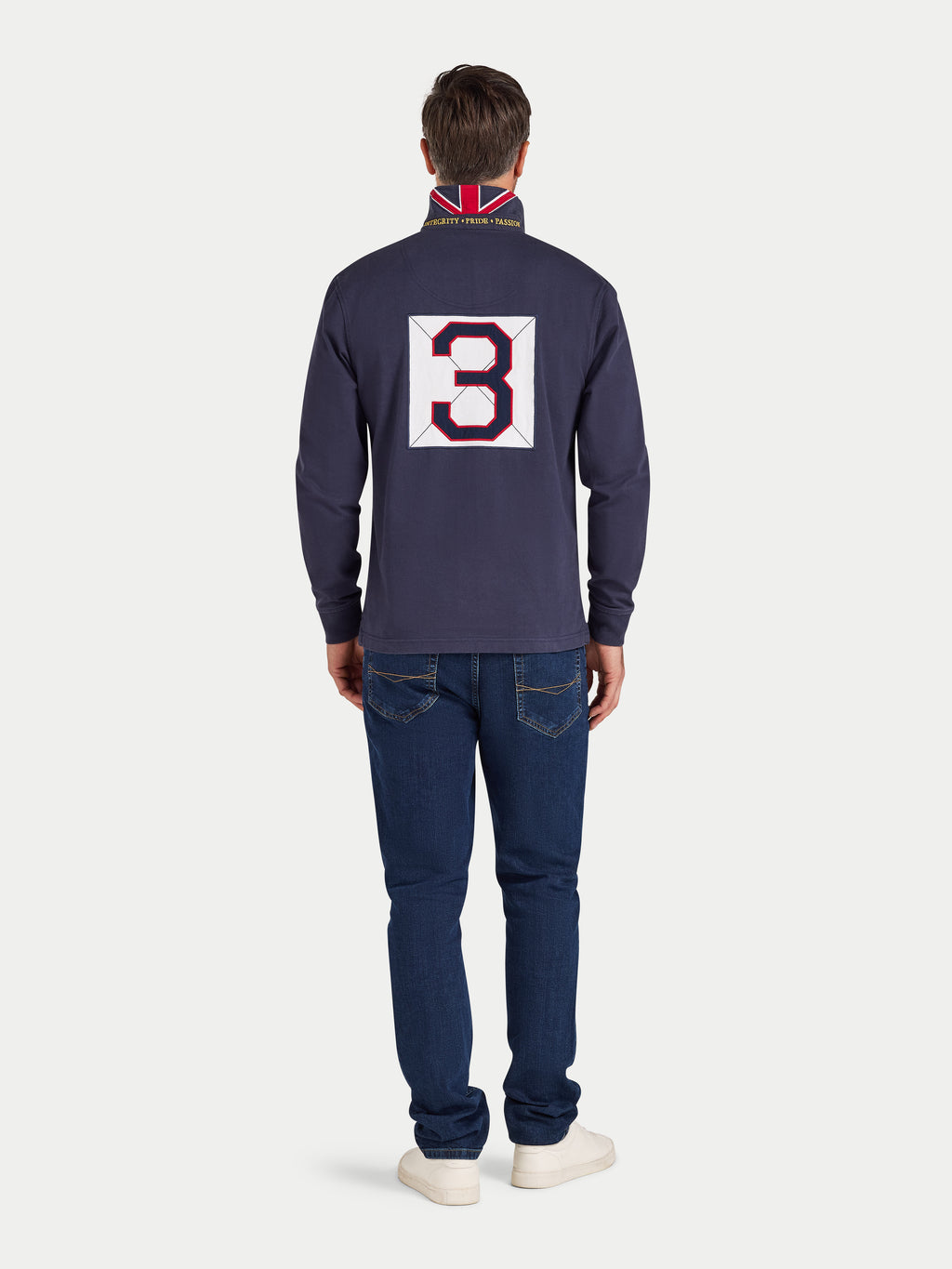 Man wearing a navy blue long-sleeve shirt with a large number '3' on the back, standing against a white background.