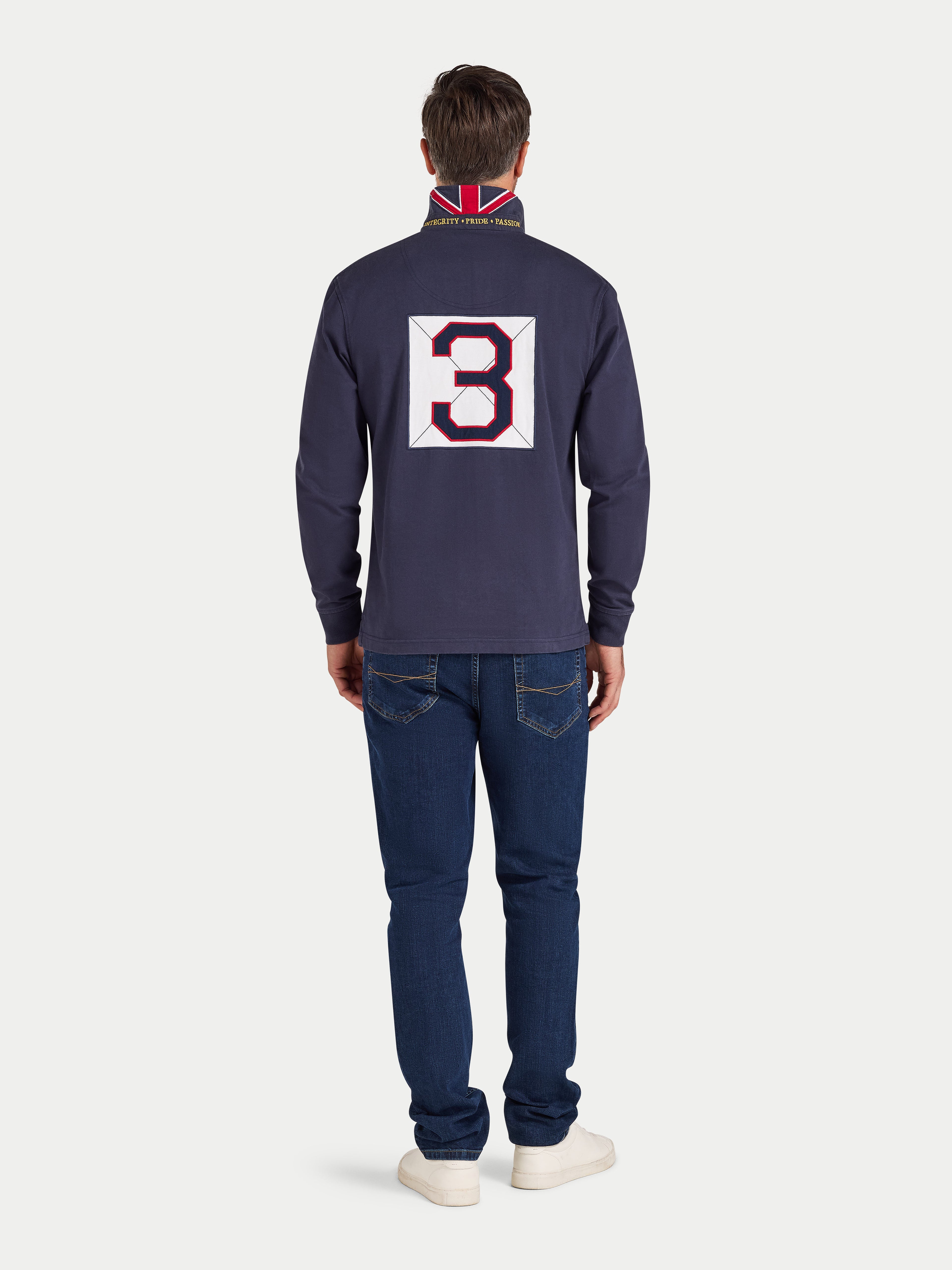 Man wearing a navy blue long-sleeve shirt with a large number '3' on the back, standing against a white background.