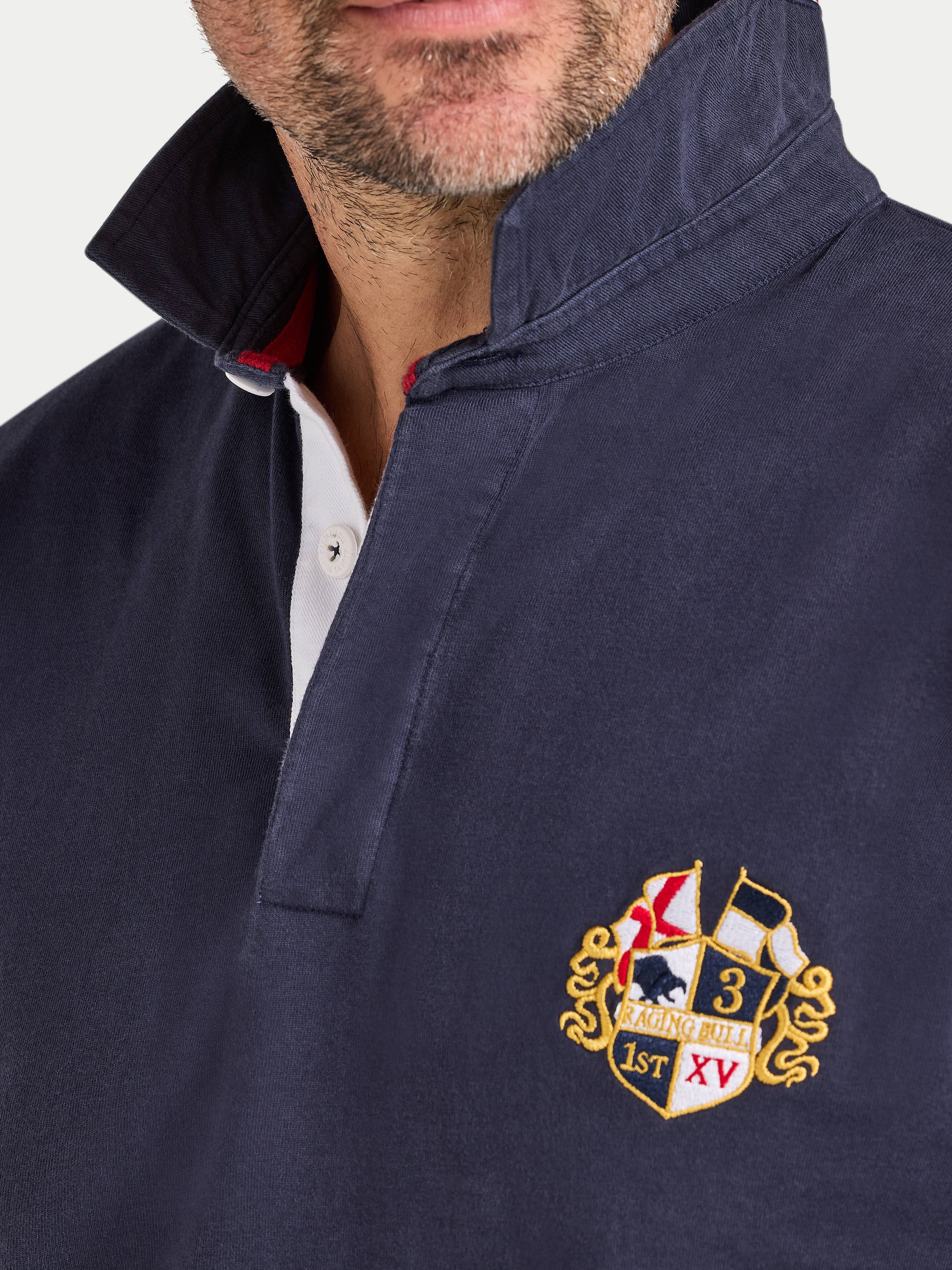 Navy blue jacket with a embroidered crest on the chest against a white background