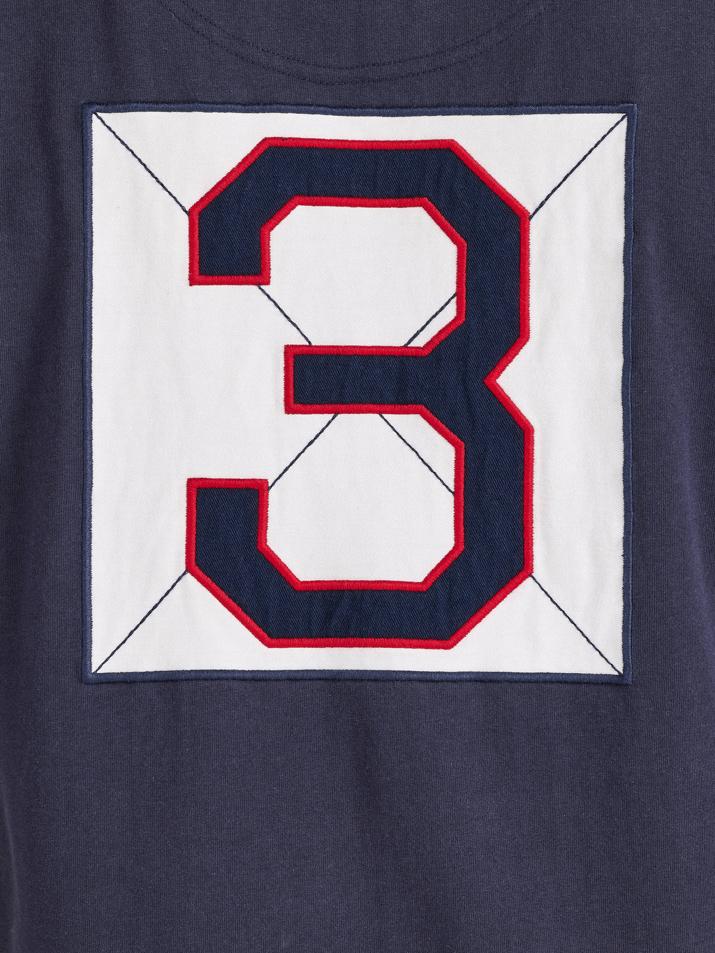 Navy blue shirt with a large red and white number '3' on a white background