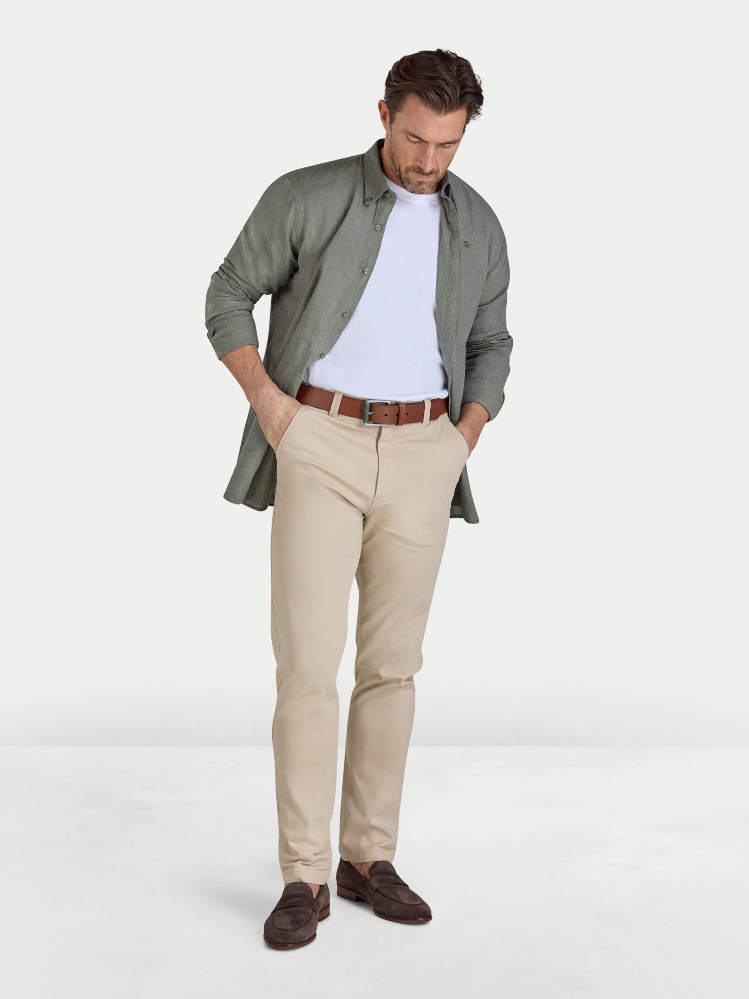 Man wearing Raging Bull Classic Linen Long Sleeve Shirt in Olive, Classic Organic T-shirt in white and Classic Chino Trousers in tan, available in sizes S-6XL