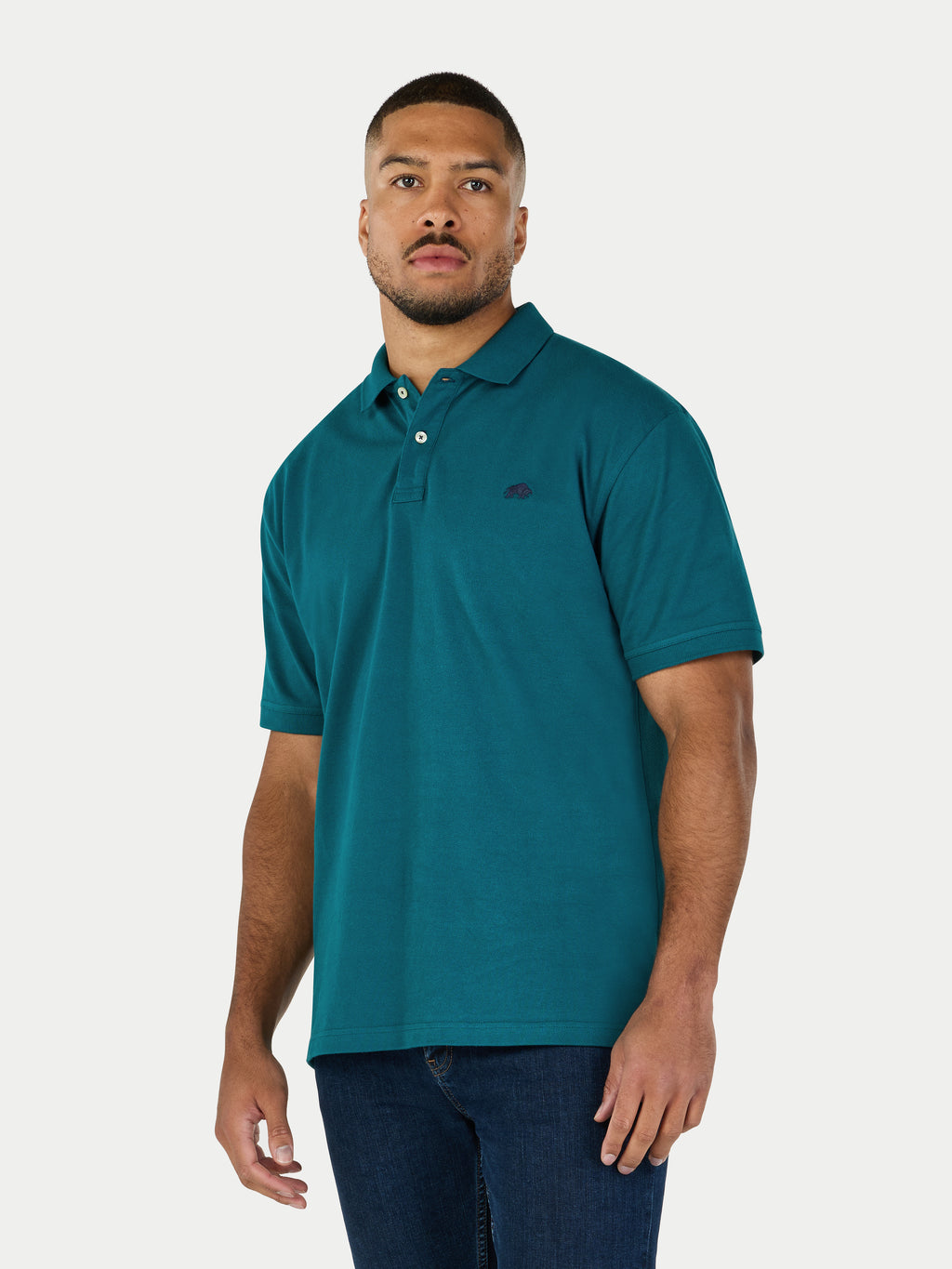 Man wearing a teal polo shirt on a white background