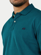Teal polo shirt with a small logo on a white background