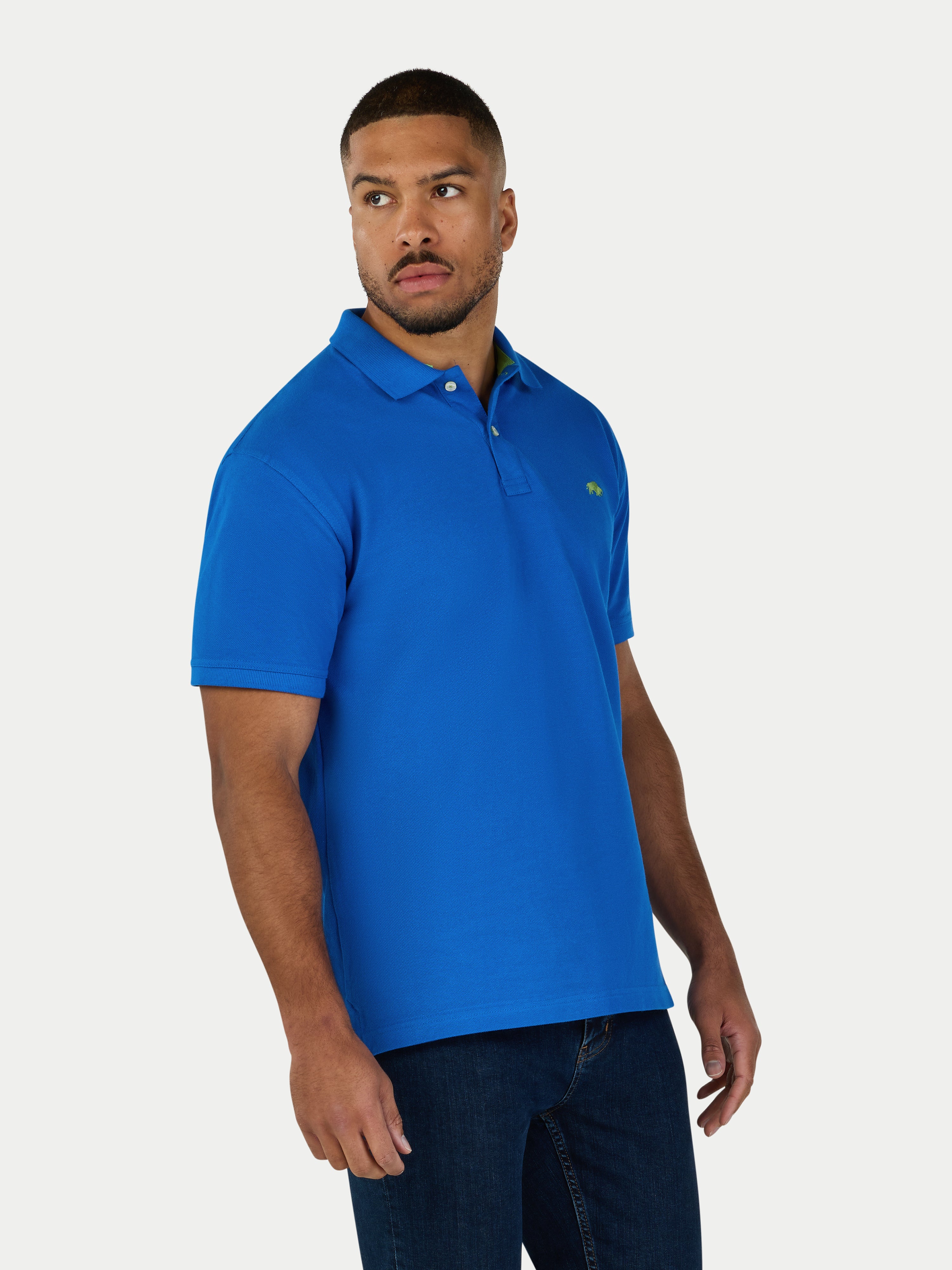 Man wearing a blue polo shirt with a logo on a white background