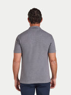 Man wearing a gray polo shirt on a white background