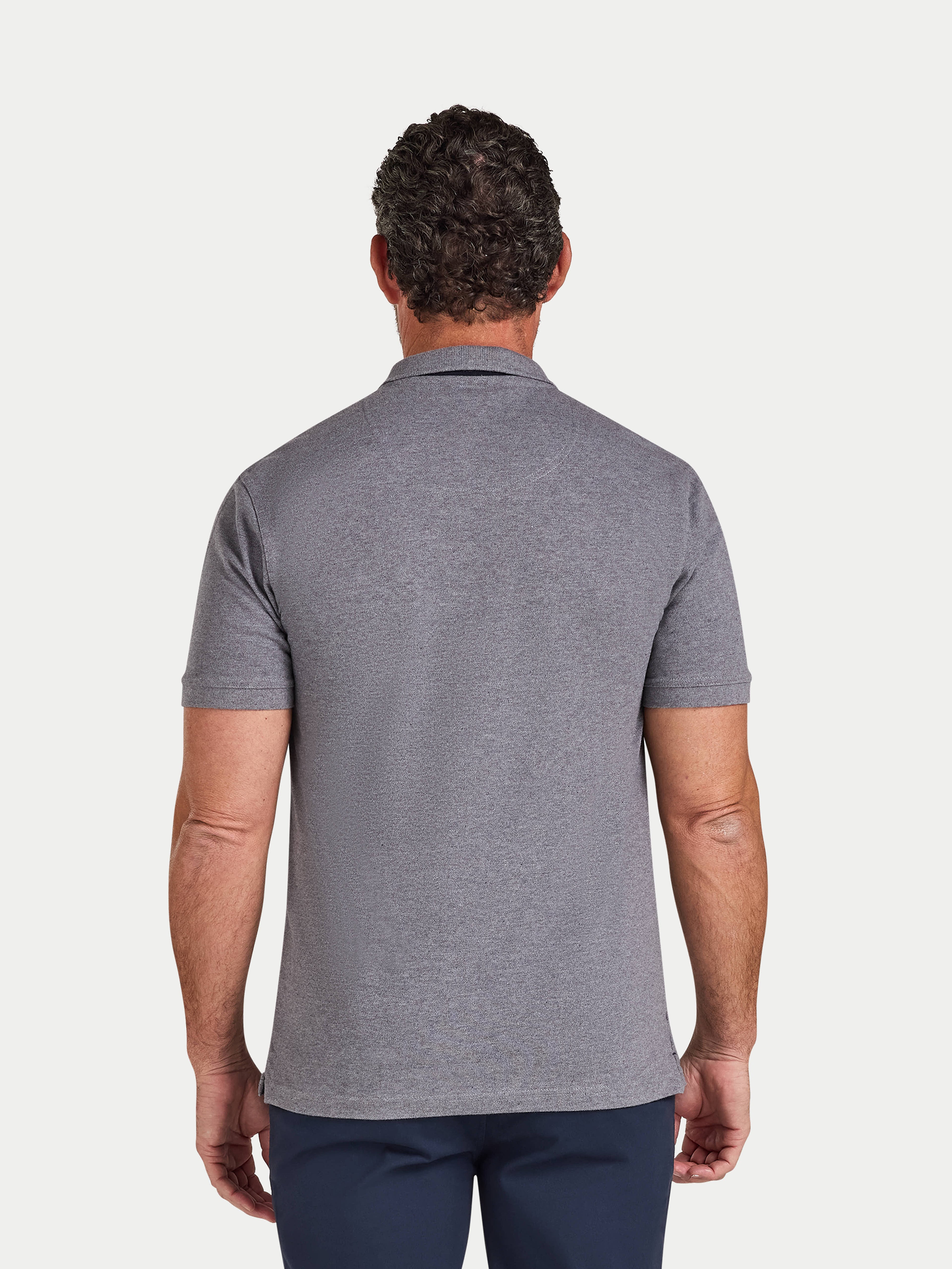 Man wearing a gray polo shirt on a white background