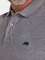 Close-up of a gray polo shirt with a small logo on a white background