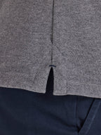 Close-up of a gray textured fabric with a zipper, on a dark background.