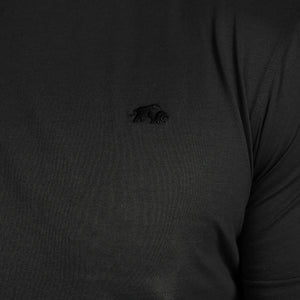 Black long-sleeve shirt with a small logo on the chest against a black background