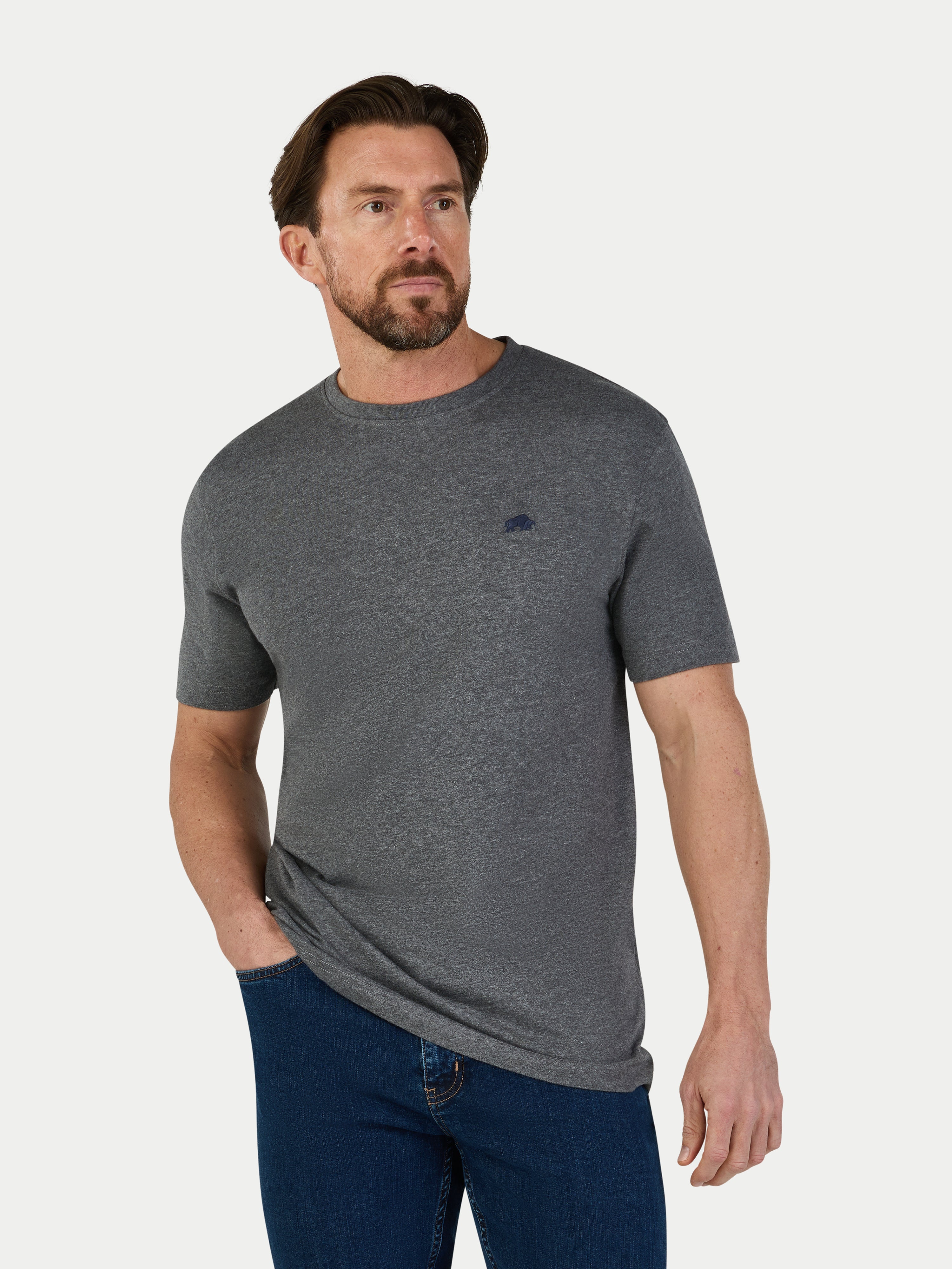 Man wearing a gray t-shirt with a small Raging Bull logo on a white background