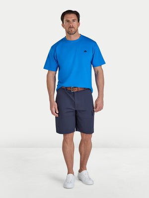 Man wearing a blue t-shirt and navy shorts on a white background