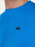 Blue t-shirt with a black bear logo on a white background