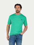 Man wearing a green t-shirt with a small Raging Bull logo on a white background