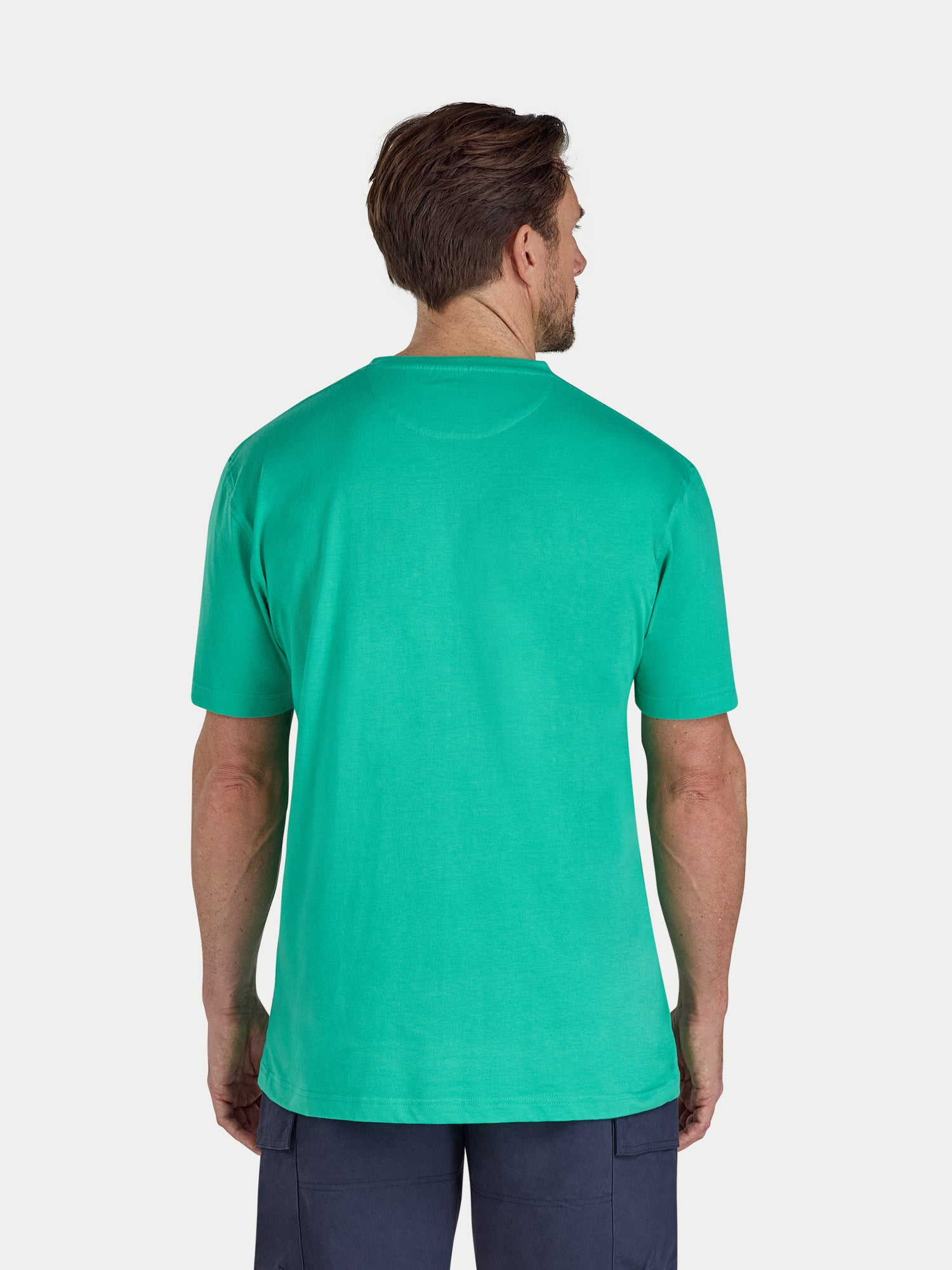Man wearing a green t-shirt on a white background