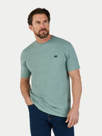 Man wearing a green t-shirt with a small Raging Bull logo on a white background