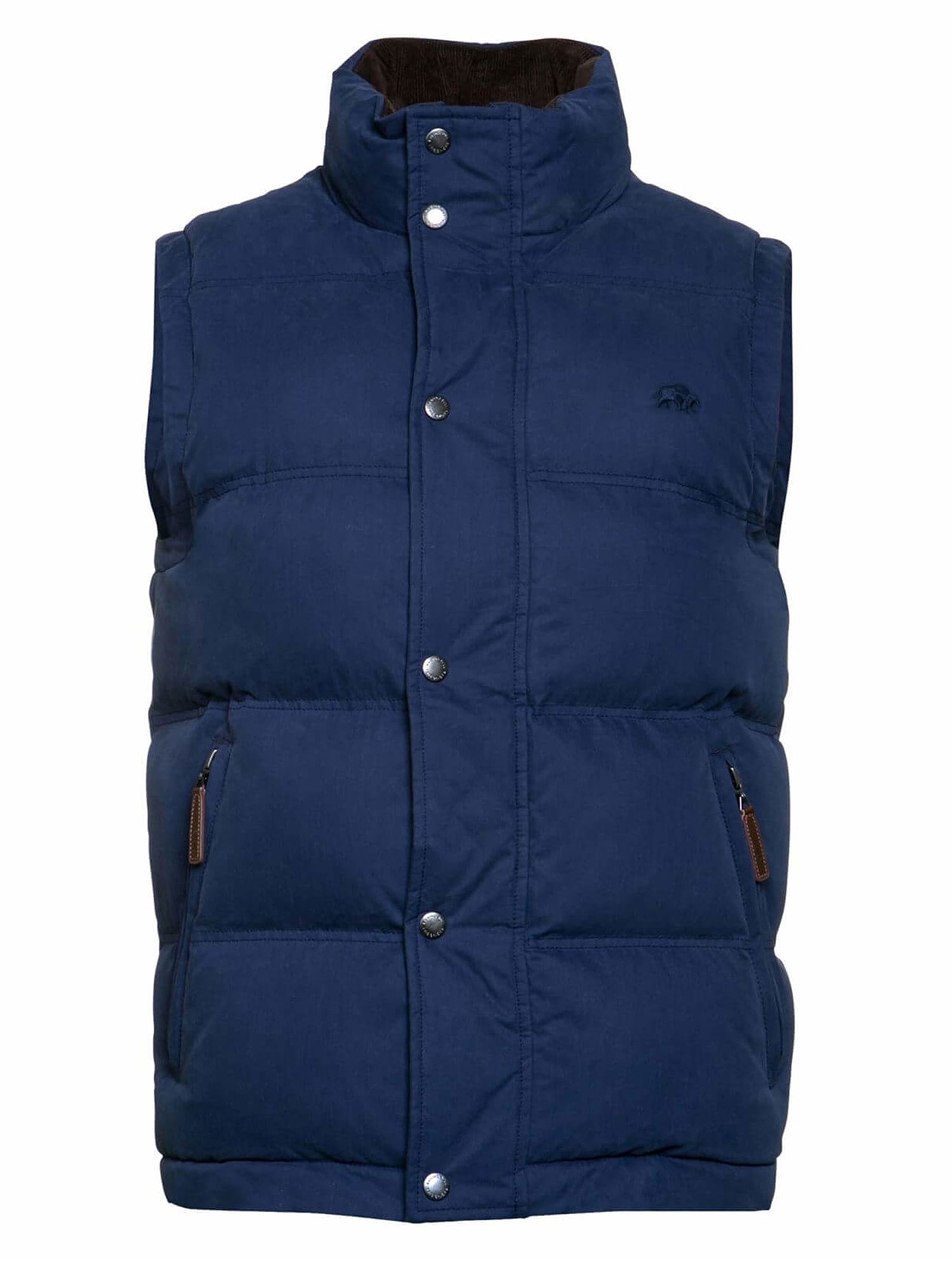 A male model wearing a navy padded gilet with zip pockets and a zip through fastening, standing in front of a sports stadium seating.