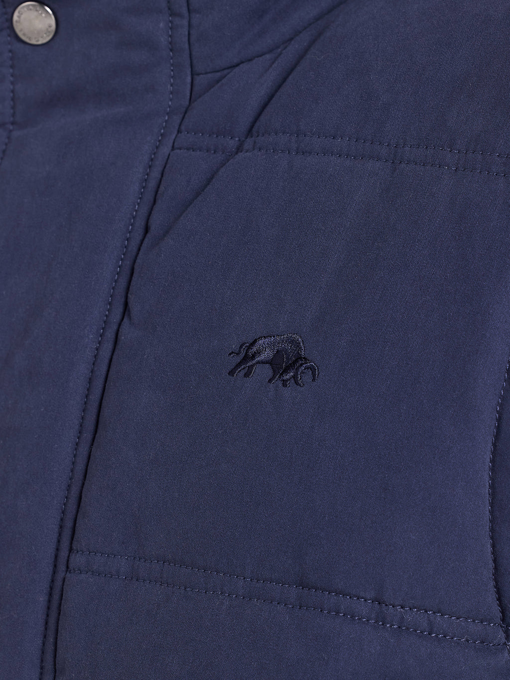 Close-up of a blue jacket with an embroidered logo on the chest pocket.
