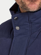 Close-up of a navy blue jacket with buttons on a light gray background