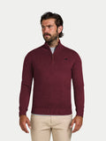 Man wearing a burgundy sweater with a logo on a light gray background