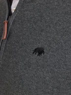 Close-up of a dark gray knit jumper with a small Raging Bull emblem.