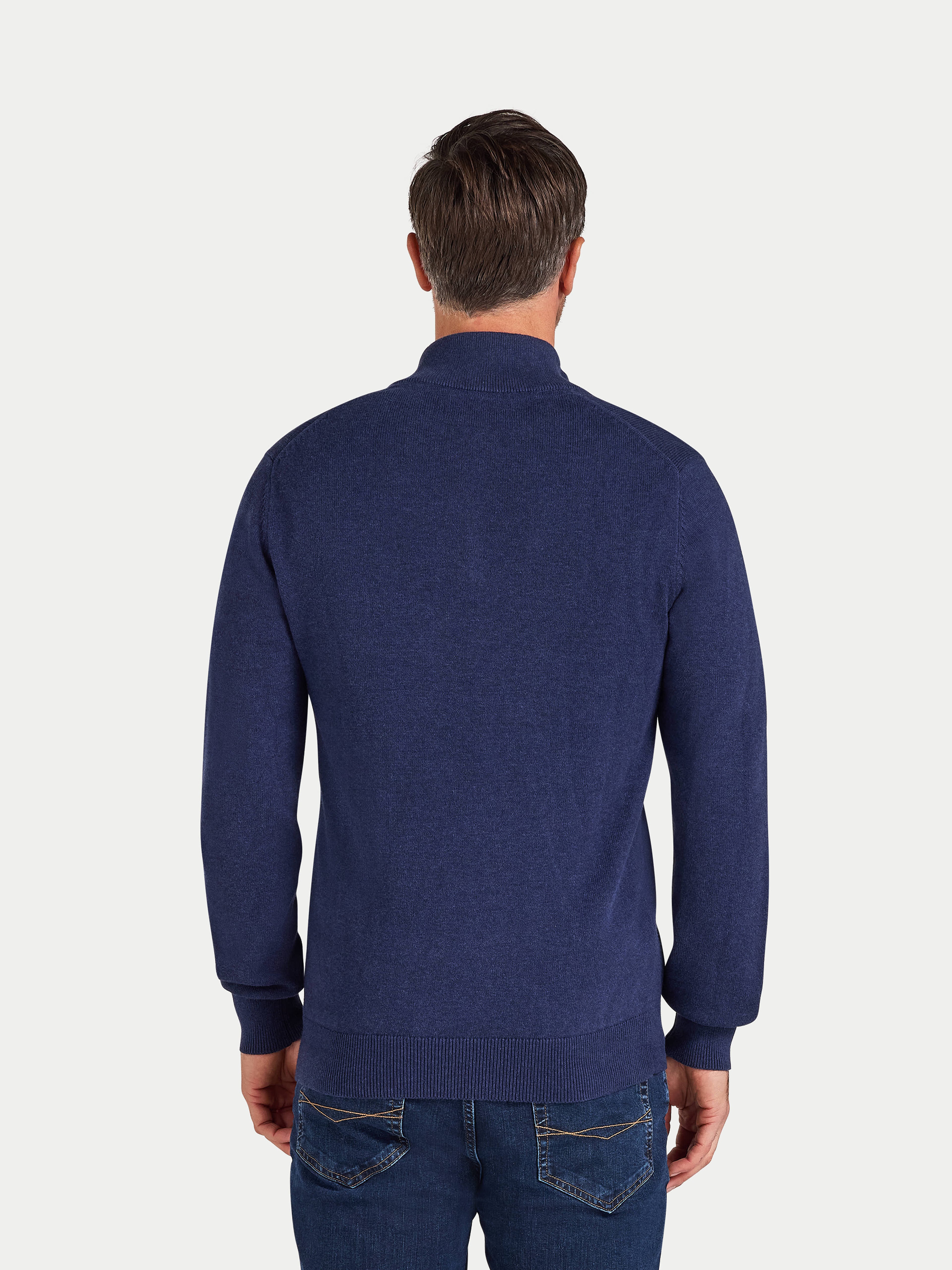 Man wearing a blue sweater on a white background