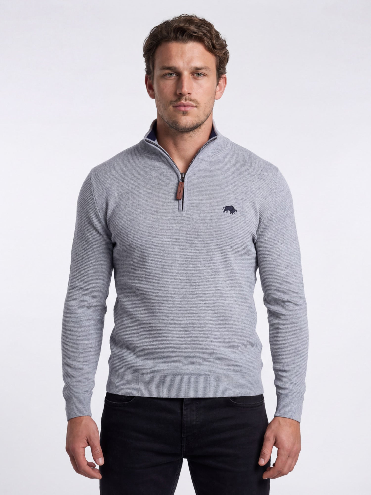 Man wearing a gray quarter-zip sweater with a logo on a white background
