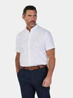 Man wearing a white short-sleeve shirt and navy pants on a white background