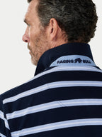Man wearing a navy and white striped shirt with 'Raging Bull' logo on a light gray background