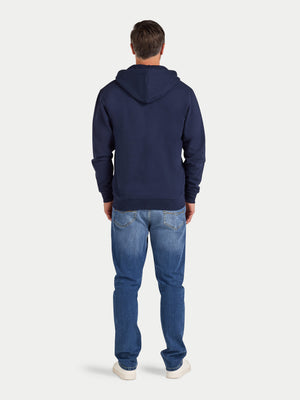 Person wearing a navy hoodie and blue jeans on a white background