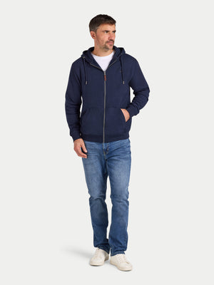 Man wearing a navy blue hoodie and jeans on a white background
