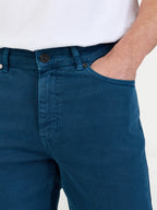 Blue pants worn by a person on a white background