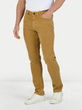 Man wearing Coloured Denim Stretch Trouser - Sand, front detail. 
